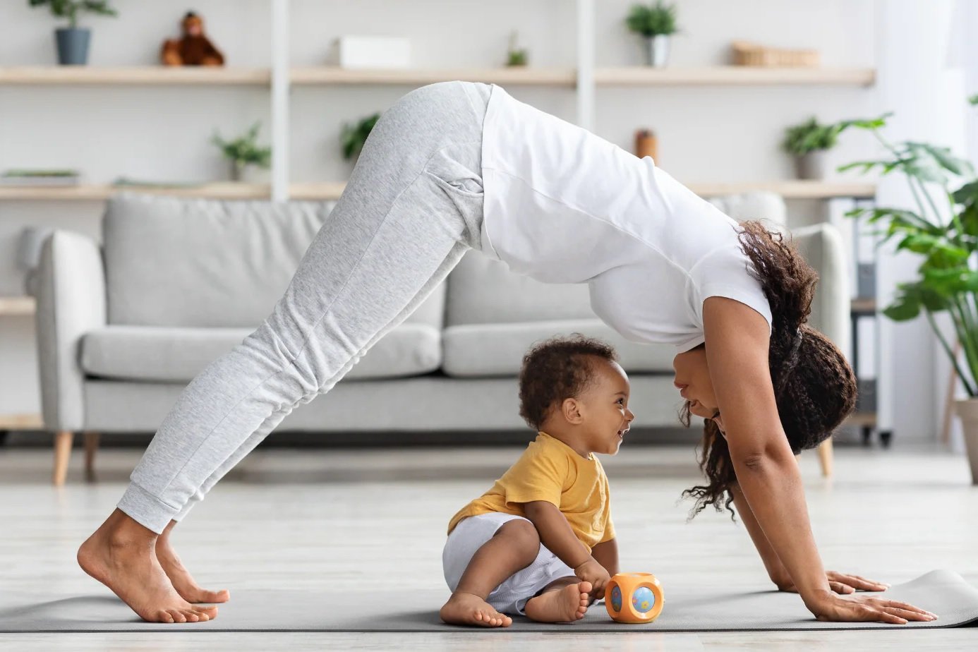 A mother doing gentle core and pelvic floor recovery exercises